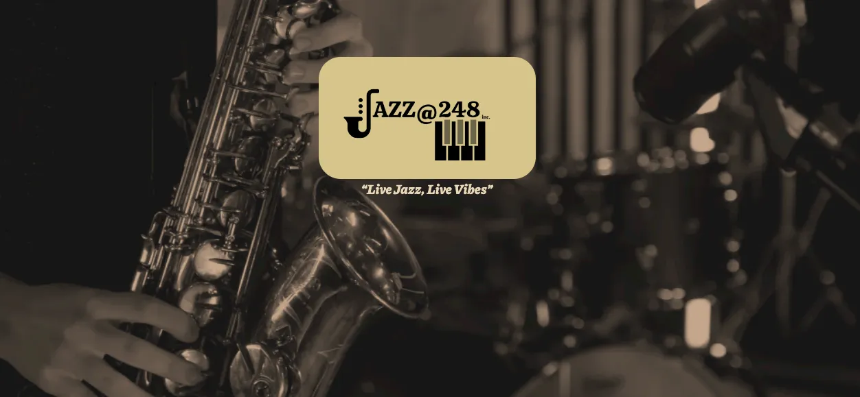 Close-up of a saxophone and double bass with drums in the background